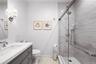 Bathroom featuring vanity, a shower stall, and light tile patterned flooring