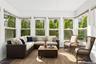 digitally furnished sun room off of first floor bedroom
