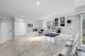 Kitchen featuring glass insert cabinets, a peninsula, a breakfast bar area, light stone countertops, and recessed lighting