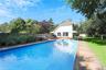 View of pool with an outbuilding, a patio, a fenced backyard, view of scattered trees, and an outdoor hangout area