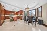 Gourmet kitchen with wood cabinetry, recessed lighting, and a center island with countertop seating