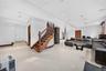 Spacious room featuring light-toned flooring, recessed lighting, and crown molding