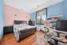 Hardwood flooring, recessed lighting, crown molding, and a large arched window with a wood frame