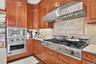 Cherry wood cabinetry complemented by granite countertops