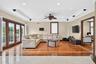 Hardwood flooring with a marble border, recessed lighting, crown molding, double French doors, and a ceiling fan