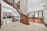 Grand entry featuring a curved staircase with ornate wrought iron balusters and wood banister
