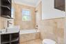 Wall-mounted vanity with a rectangular basin, brushed nickel faucet, and integrated shelving
