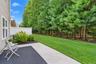 Private rear outdoor space bordered by mature landscaping