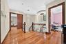 Hardwood flooring throughout, crown molding, recessed lighting, and ornate wrought iron railing
