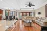 Recessed lighting, crown molding, wood-finish flooring, tiled flooring, and a ceiling fan