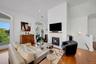 Large living area with double french doors leading out to 40 ft terrace with views of the LI Sound