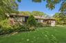 Cedar shake siding, attached garage with carriage-style door