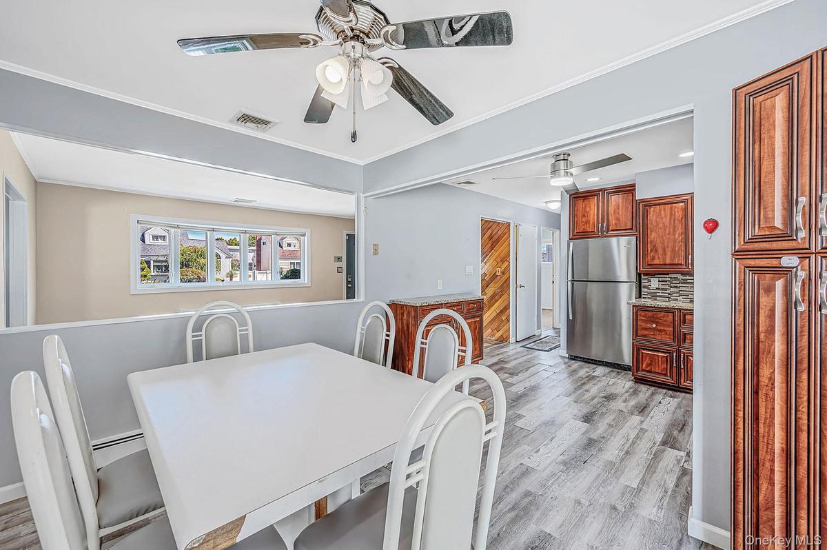 Updated EIK with SS Appliances, Gas Cooking, Large Dining Area, Sliders to Sunroom