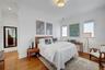 Spacious primary bedroom featuring a walk-in closet and 2nd custom closet. Hardwood floors throughout.