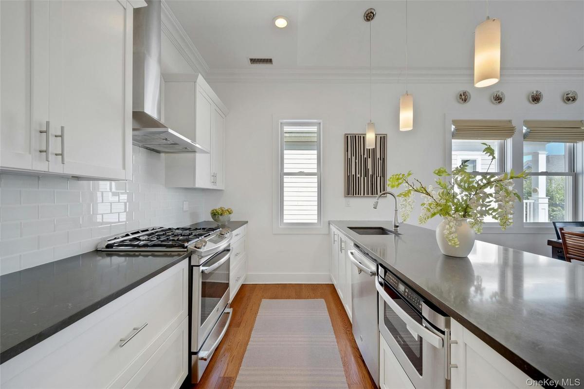 Beautiful Caesarstone island and countertops and hardwood flooring throughout