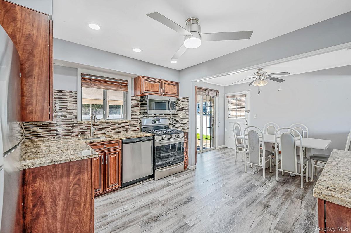 Updated EIK with SS Appliances, Gas Cooking, Large Dining Area, Sliders to Sunroom