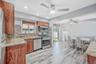 Updated EIK with SS Appliances, Gas Cooking, Large Dining Area, Sliders to Sunroom