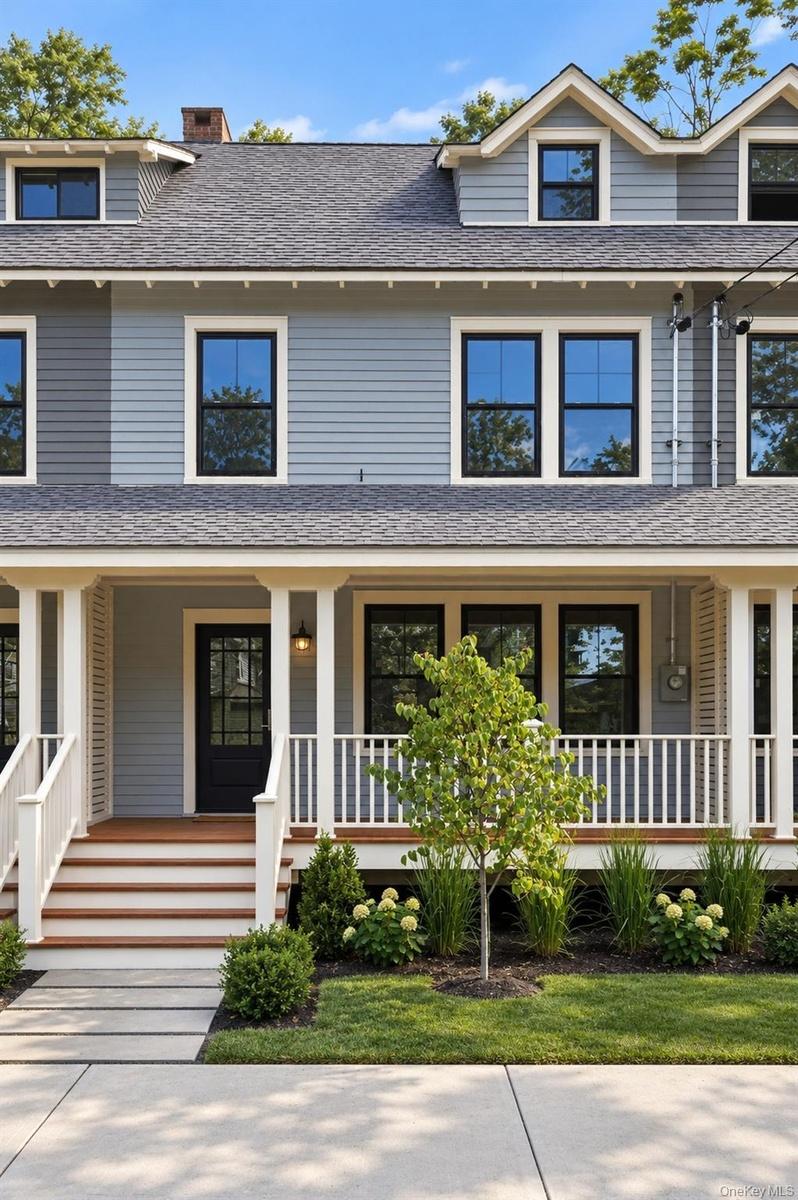 Light blue siding exterior with white trim and dark-framed windows