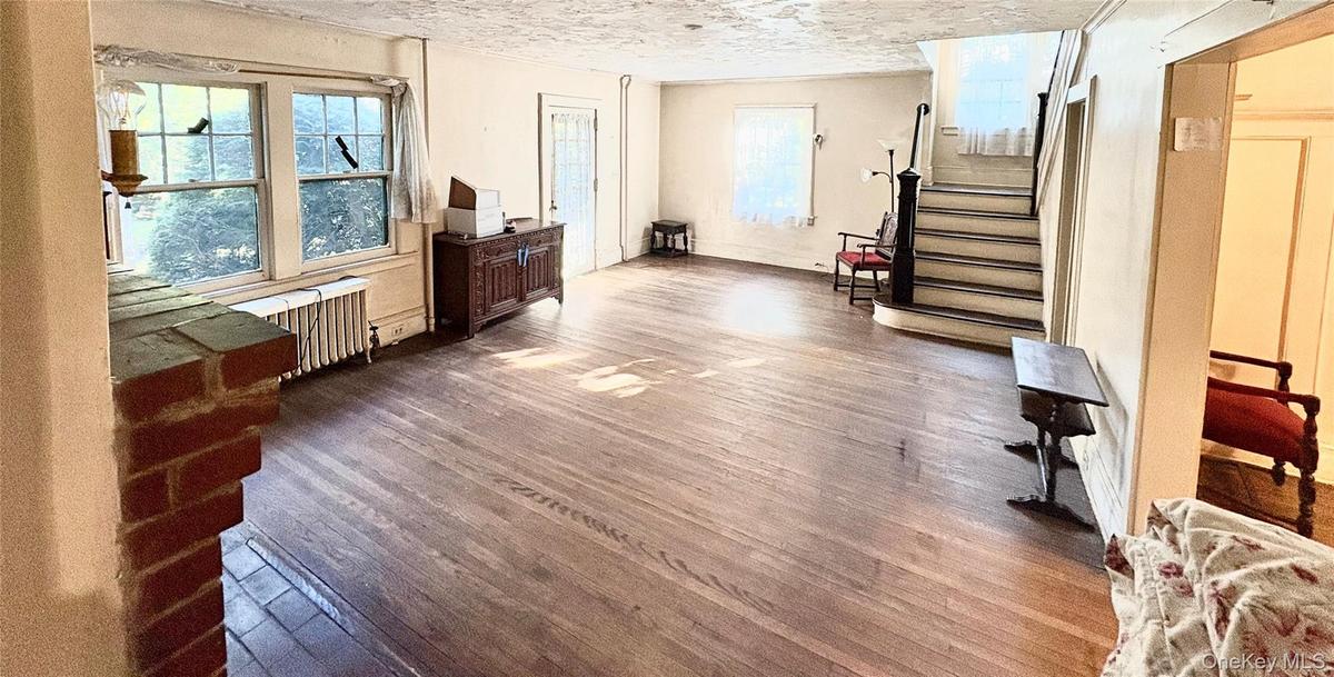 Large 24 X 20 Living room with hard wood floors and wood burning fireplace