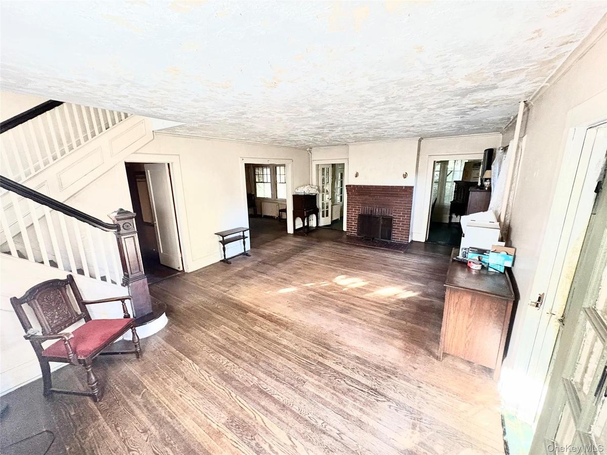 Large 24 X 20 Living room with hard wood floors and wood burning fireplace.