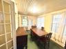 Sunroom, Office, Sitting Room with hardwood floors and french door into screened porch.