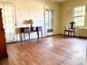 Bedroom with hardwood floors and french doors leading to outside patio, west facing.
