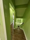 Hallway with wood-finish flooring and white baseboards