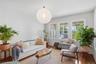 Hardwood flooring, white walls, triple window unit, white trim, and a contemporary ceiling fixture