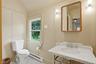 Pedestal vanity featuring a white marble countertop and integrated basin