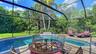 Screened pool area with waterfall.