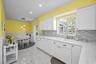 Kitchen with canned lighting and door to the screened lanai