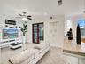 VIEW OF FAMILY ROOM WITH GLASS DOOR LEADING TO POOL AREA