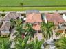 AERIAL VIEW OF FRONT OF PROPERTY LINED WITH MAJESTIC AND TALL PALM TREES BACKS TO IMPRESSIVE MILES OF CORN FIELDS FEELING THE IN TOUCH WITH NATURE.
