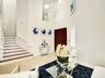 ELEGANT ENTRY AND LIVING AREA WITH VERY HIGH CEILINGS AND SPECTACULAR CONTEMPORARY GEOMETRIC CHANDELIER.