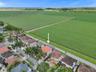 AERIAL VIEW OF COMMUNITY WITH IMPRESSIVE VIEW OF FIELD IN BACK OF PROPERTY.