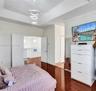 MASTER BEDROOM WITH CHANDELIER AND OUBLE DOORS LEADING TO LOFT