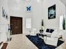 ELEGANT ENTRY WITH VERY HIGH CEILING AND CONTEMPORARY GEOMETRIC CHANDELIER.