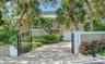 Welcome to 5188 Siesta Woods Drive, a private Siesta Key retreat surrounded by lush tropical landscaping.