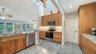 Additional view of the remodeled kitchen with abundant cabinetry and workspace.