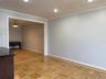 Recessed lighting illuminates the space, featuring crown molding and light-toned walls