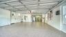 Oversized two-car garage with resurfaced and sealed floor and additional storage.
