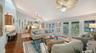 Spacious living room filled with natural light and opening to the covered balcony.