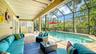 Covered outdoor living area overlooking the heated saltwater pool.