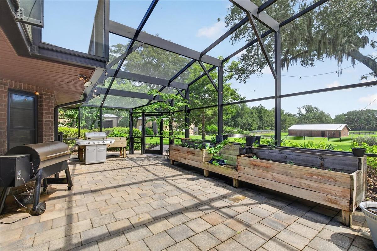 screened lanai by pool / herb garden / grilling area