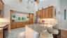 Kitchen opens directly to the main living spaces for effortless entertaining.Remodeled kitchen with granite countertops, custom cabinetry and stainles
