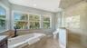 Spacious primary bath with jetted tub, separate shower and abundant natural light.