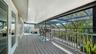 Covered screened balcony overlooking the tropical surroundings.