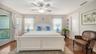 Spacious primary suite with hardwood floors and private balcony access.