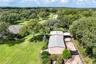 aerial of in law house/storage and equipment garage/shop along with rv/trailer parking and chicken run
