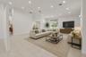 Spacious living area featuring neutral tile flooring, recessed lighting, and a ceiling fan